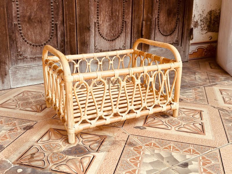 Handmade rattan doll cradle, finished with natural color and weaving details.