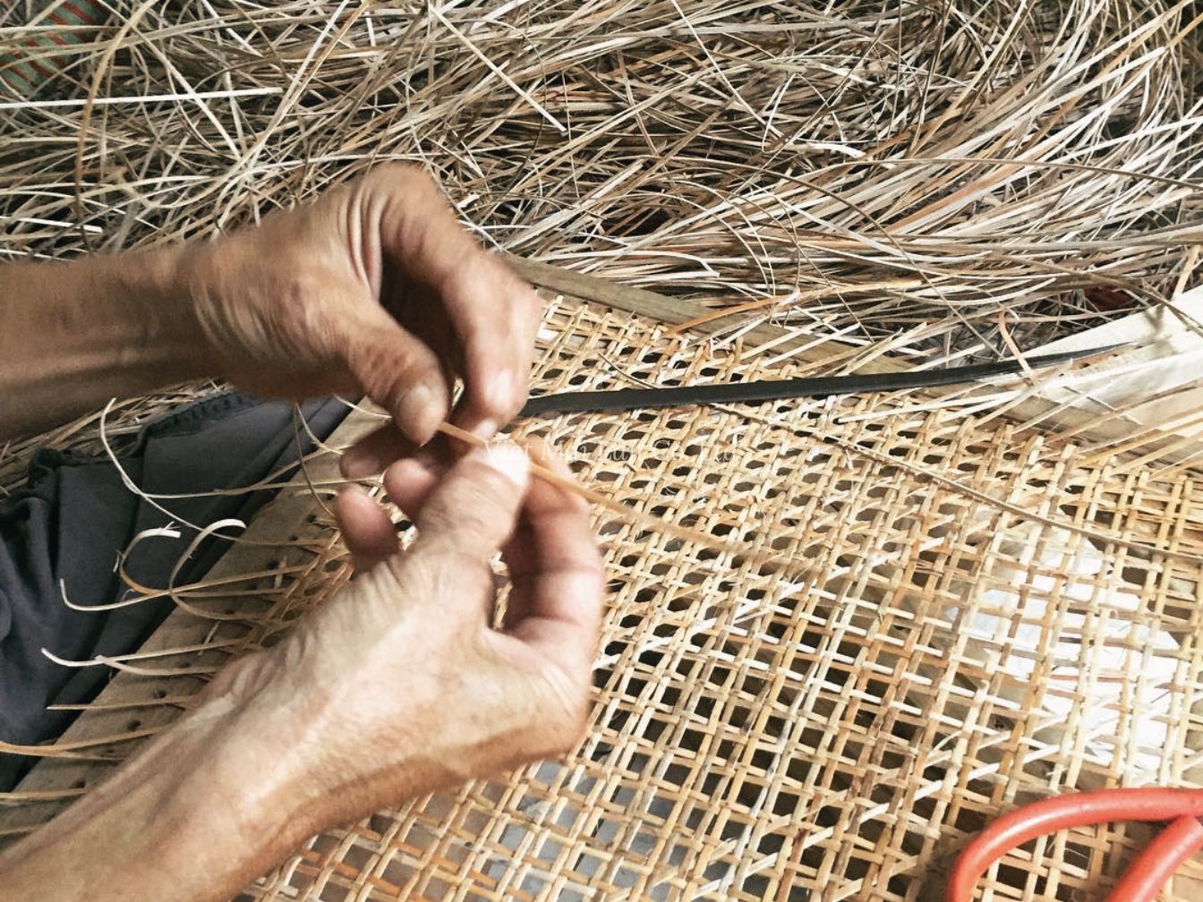 Artisan hand weaving rattan giving soul to each handcrafted piece